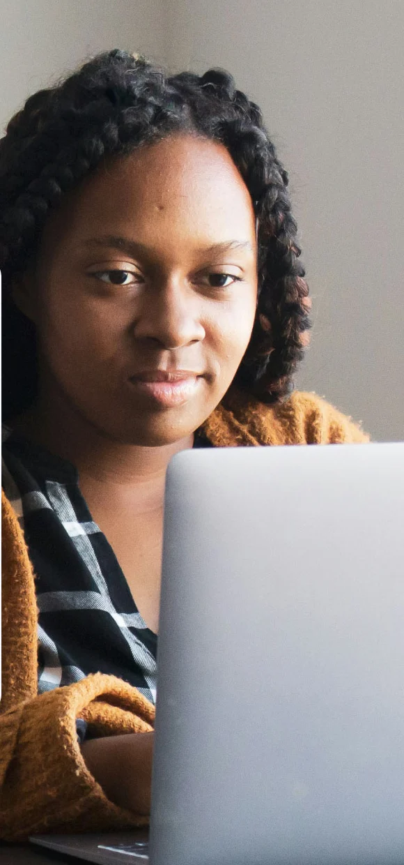 Woman at her laptop ordering from a business’s WhatsApp catalogue