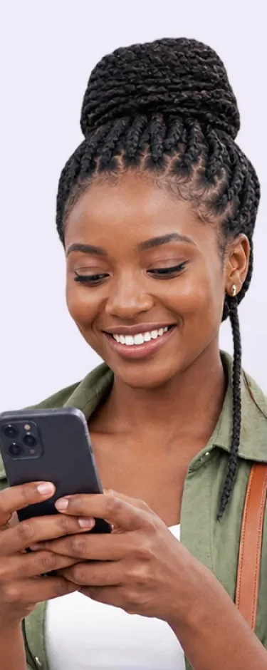 Smiling woman with braids reading a quote on her phone