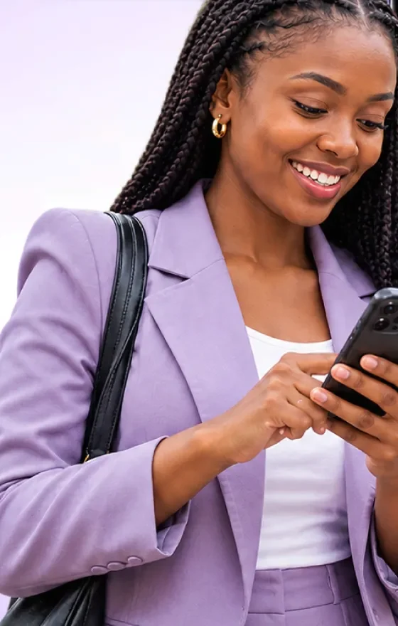Woman in a lilac blazer reading a follow-up message on her phone