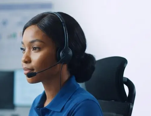Support agent with a headset working through her ticket queue
